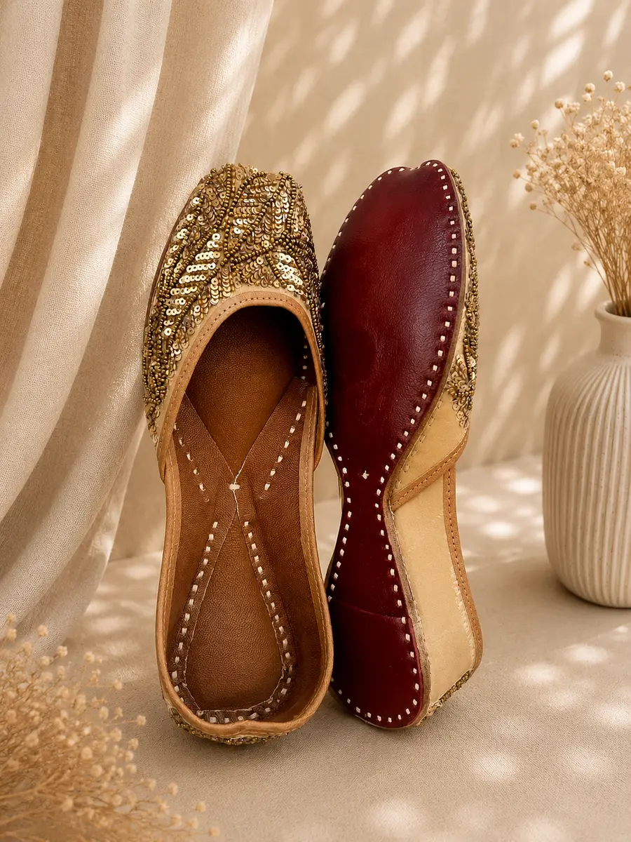 Gold Grace jutti stood beside its maroon leather sole, stamped Genuine Leather.