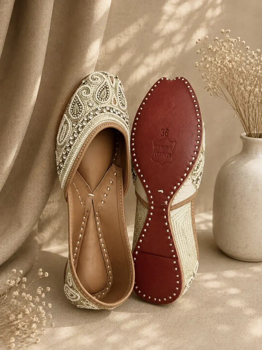 Ivory Grace jutti stood beside its red leather sole, stamped with the size and maker's mark.