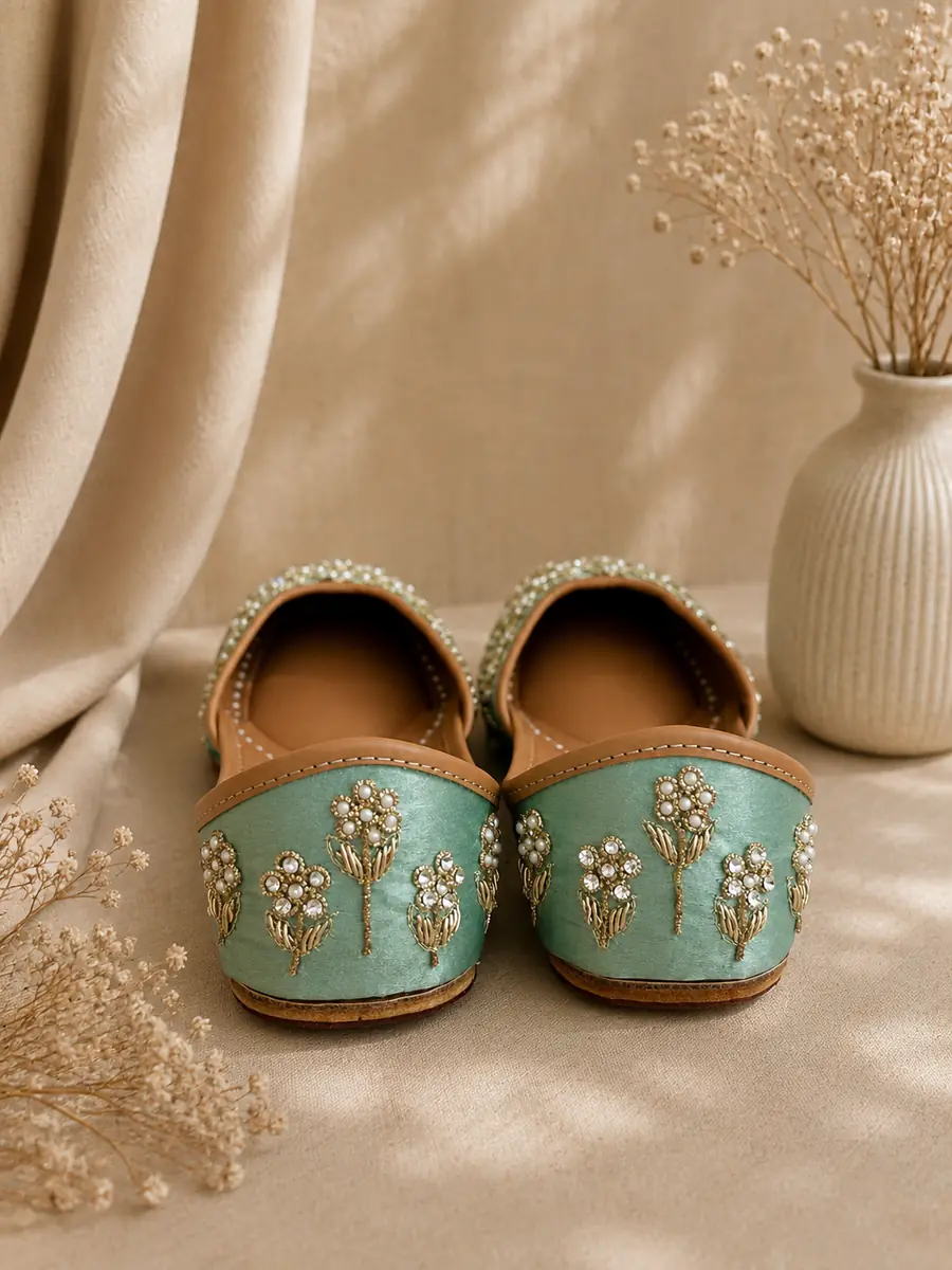 Jade Noor juttis seen from behind, the fine floral beadwork visible across each toe.