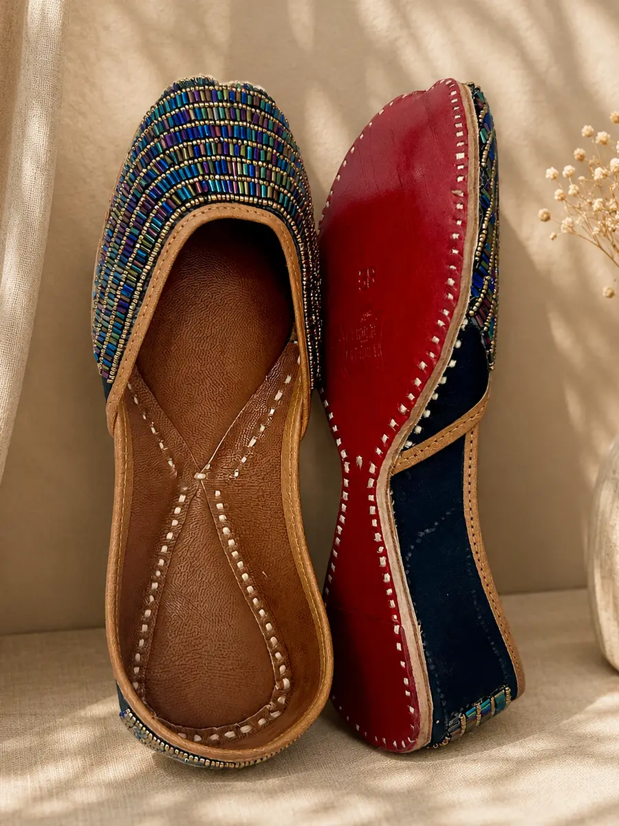 Neel Noor jutti stood beside its red leather sole, stamped Genuine Leather.