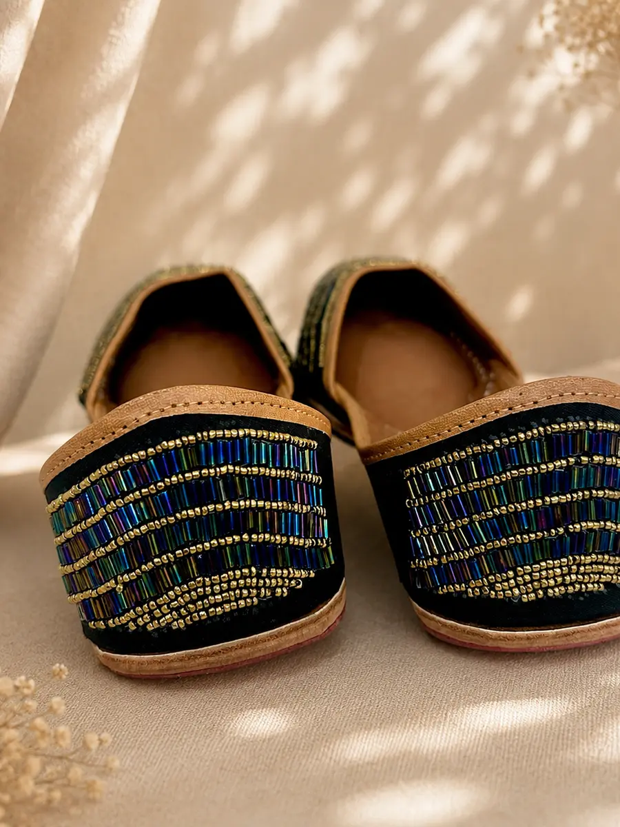 Neel Noor juttis seen from behind, the iridescent blue beadwork visible across the heel.