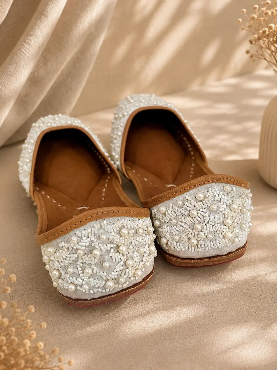 Pearl Grace juttis seen from behind, the ivory pearl beadwork visible across the heel.