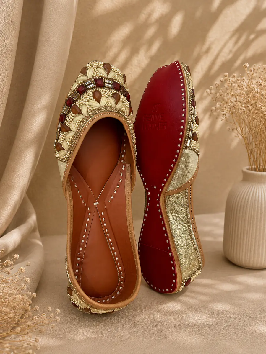 Royal Ember jutti stood beside its red leather sole, stamped Genuine Leather.